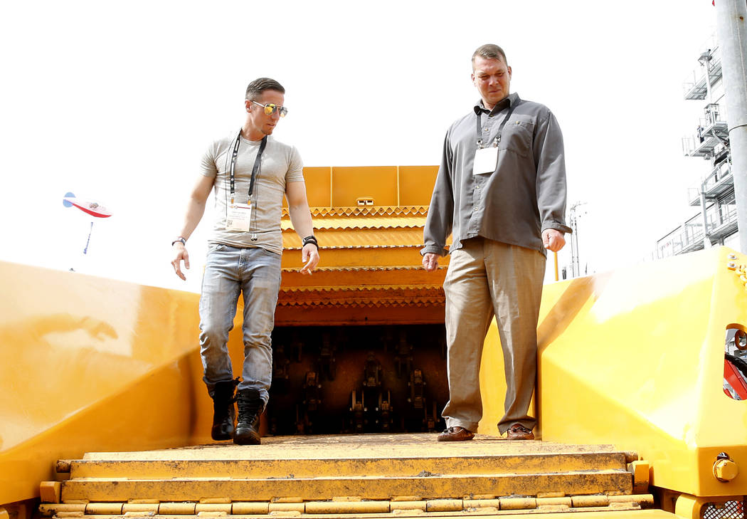 Veterans Erick Georgei, left, and Nick Butler check out the Beast 3680T Horizontal Track Grinder on Friday, March 10, 2017 during the Conexpo at the Las Vegas Convention Center. (Bizuayehu Tesfaye ...