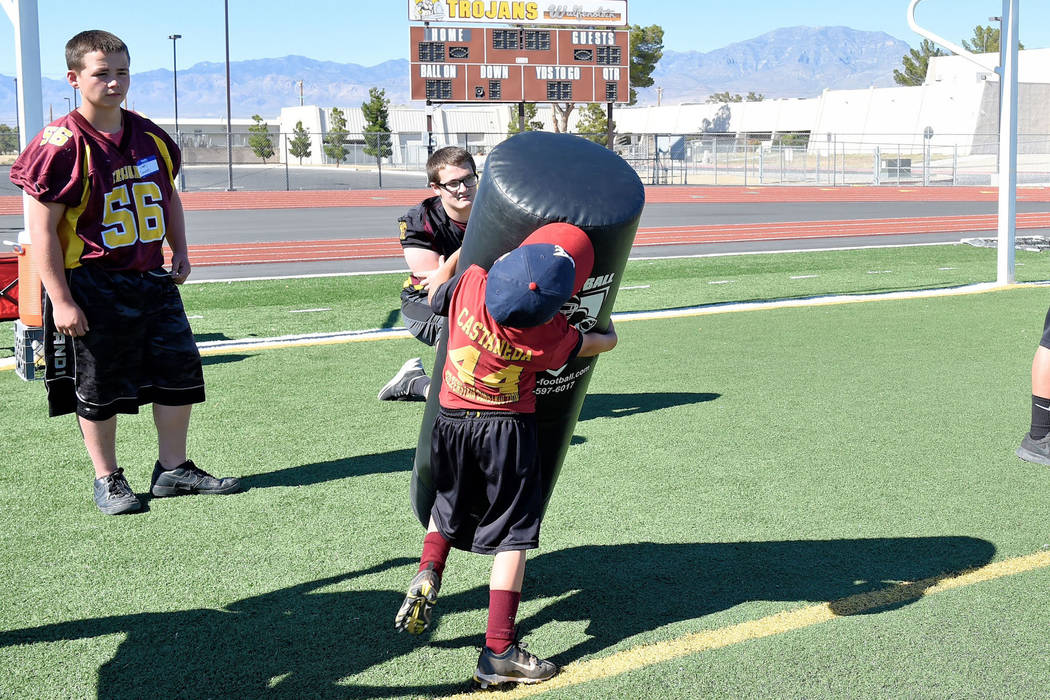 Photos by Peter Davis/Special to the Pahrump Valley Times

I got this: Cade Castaneda takes on a tackling dummy twice his size at the Junior Trojans Football camp at the high school over the weekend.