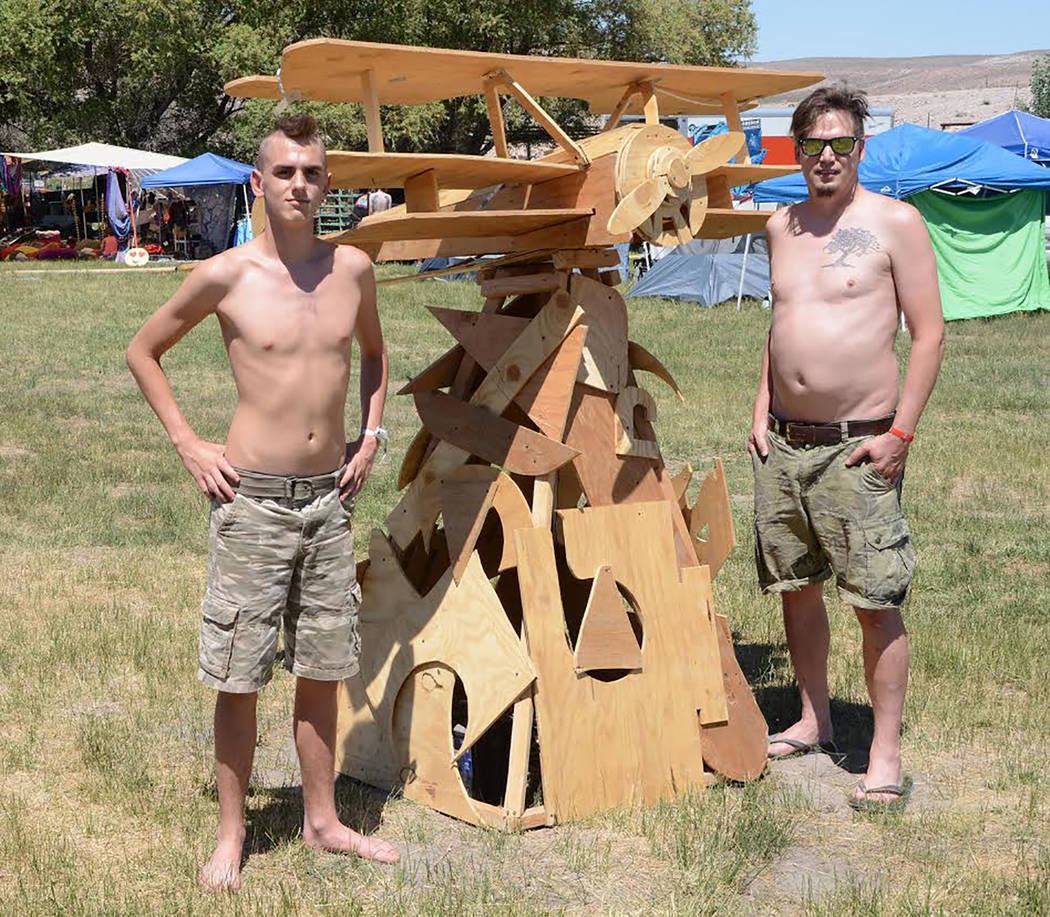 Richard Stephens/Special to the Pahrump Valley Times
Isaac and Michael Wright from the "Post-Nuclear Family" camp with a sculpture of an airplane they made from scrap wood at the Southern Nevada R ...