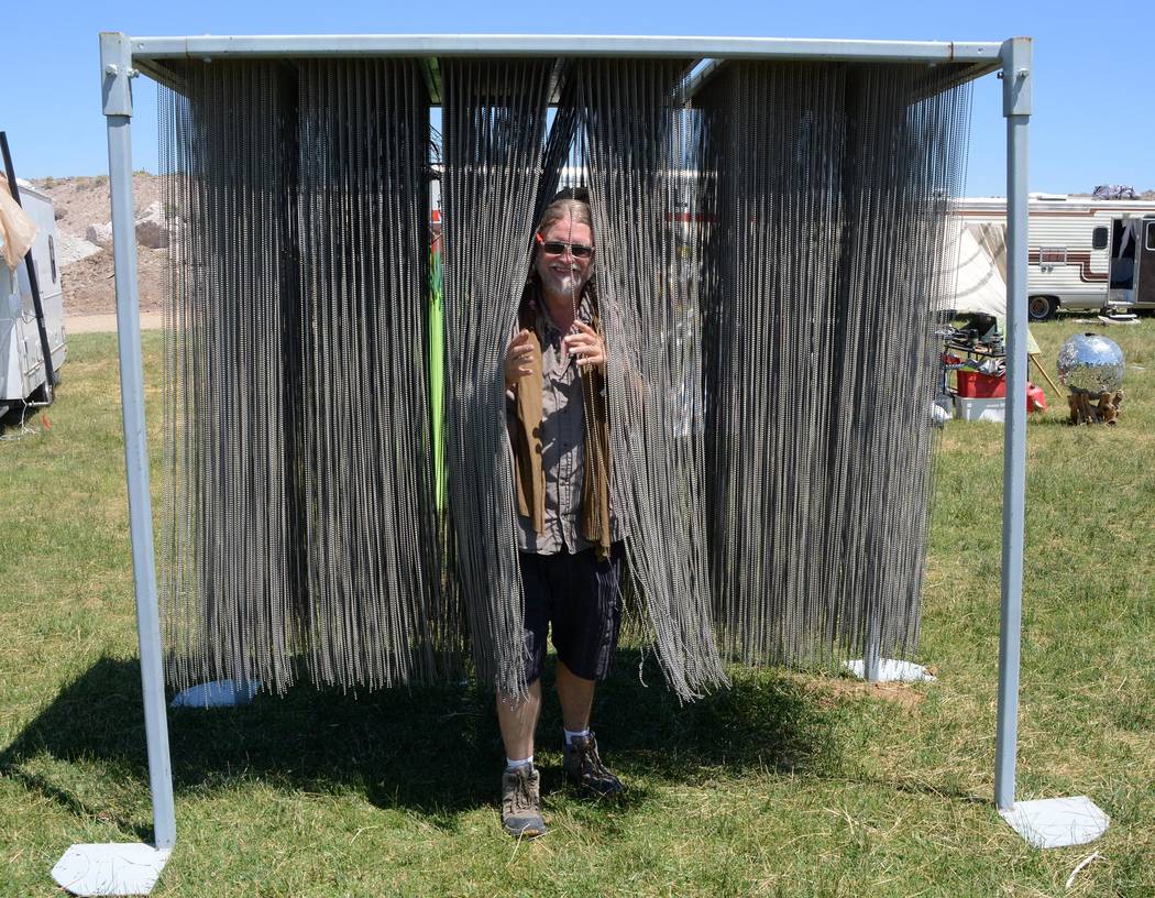Richard Stephens/Special to the Pahrump Valley Times
An attendee walks through Anthony Bondi's "Iron Curtain," a sculpture made up of more than a mile of strands of ball chain at the Southern Neva ...