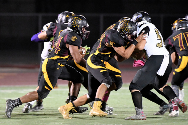 Peter Davis/Special to the Pahrump Valley Times
Aaron Fuentes looks for running space during last week’s game against Sunrise Mountain, which became the Trojans fourth victory of the year in 2016.