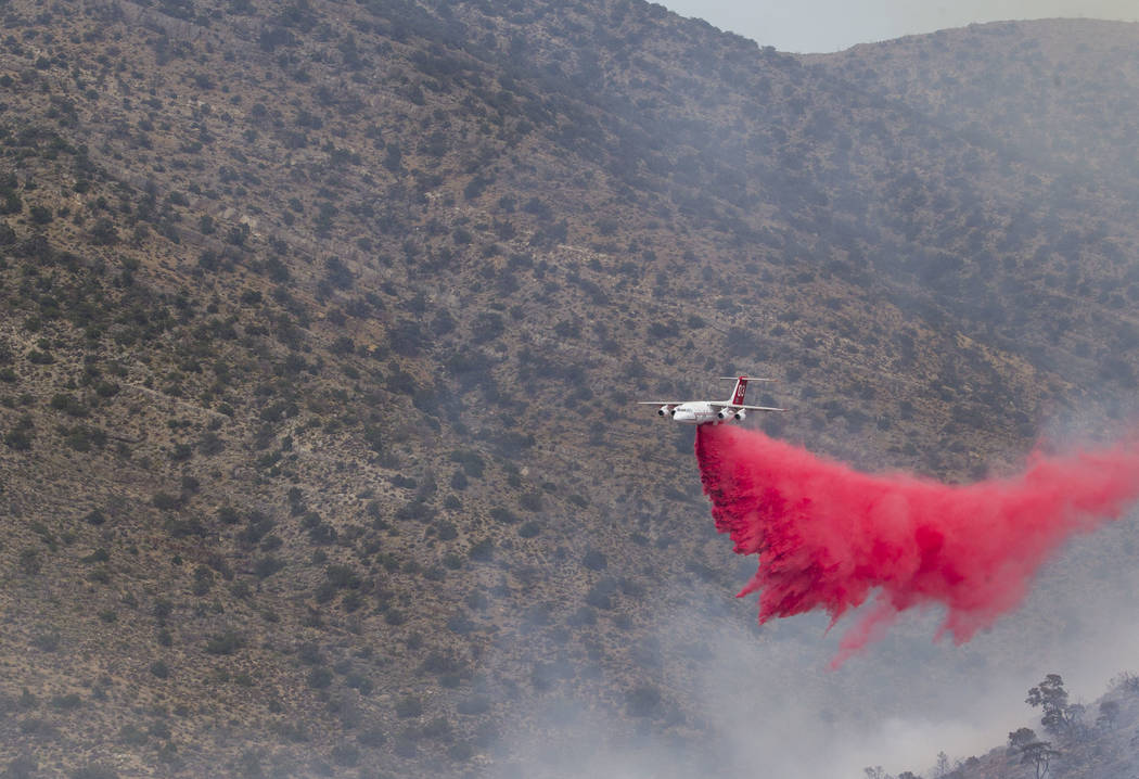 An air tanker drops a load of fire retardant while fighting a wildfire burning on the Pahrump side of Potosi Mountain on Friday, July 7, 2017.  Richard Brian Las Vegas Review-Journal @vegasphotograph