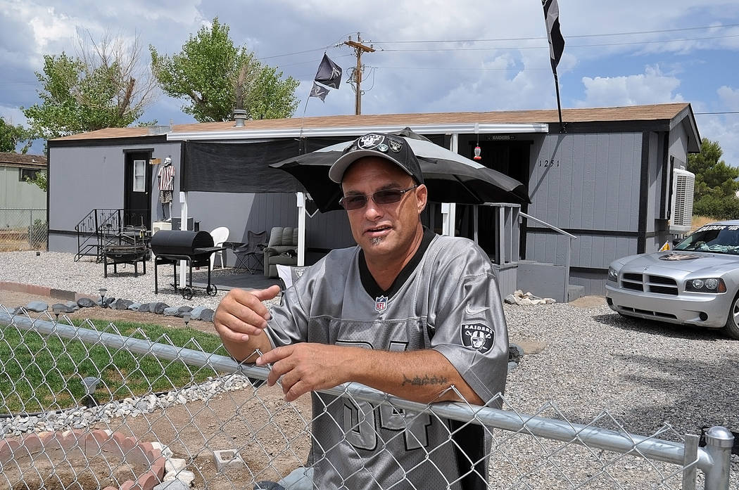 Horace Langford Jr./Pahrump Valley Times   "Raider Rob" in front of the shrine he built for his favorite team the Raiders. His house has black trim and is silver. He is wearing all Raiders colors  ...