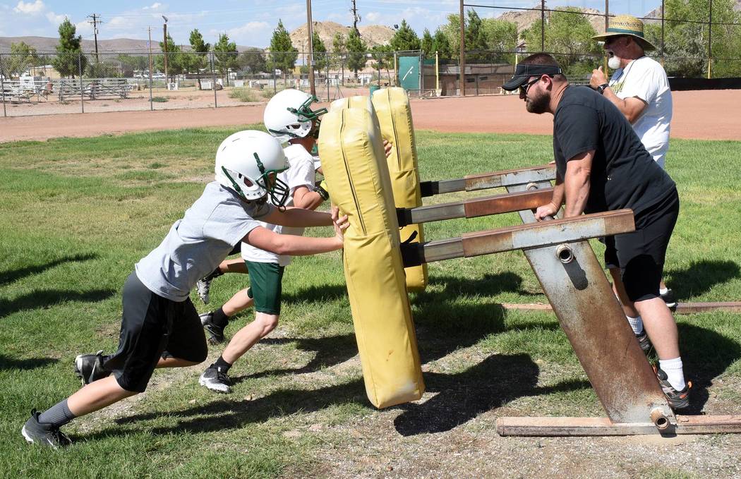 Richard Stephens/Pahrump Valley Times

Leo Verzilli (in the background) looks over his linemen on the sled. He said the line needed “beefing up.” He said he has a few linemen more than 200 pounds.