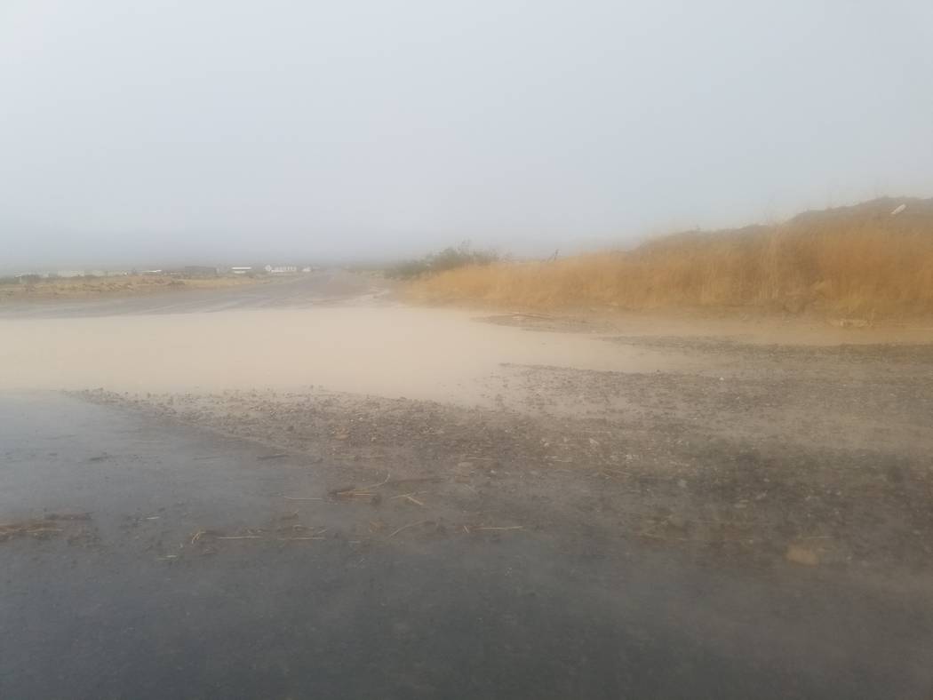 Standing water at Bell Vista Road and Highway 160 in Pahrump. Several local streets were damaged during the afternoon storm on Aug. 4, with road crews working on them into next week.