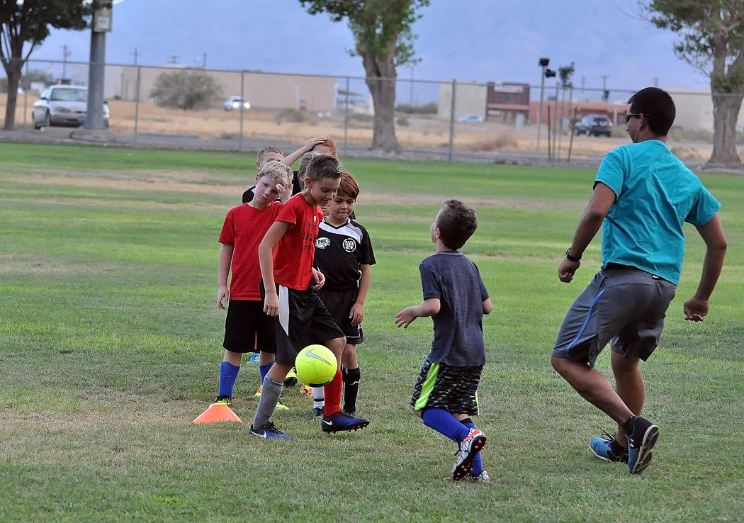Horace Langford Jr./Pahrump Valley Times

Middle school teacher Armando Veloz gets a workout at Ian Deutch Park last Thursday with some of the kids that will be playing club soccer this year. The  ...