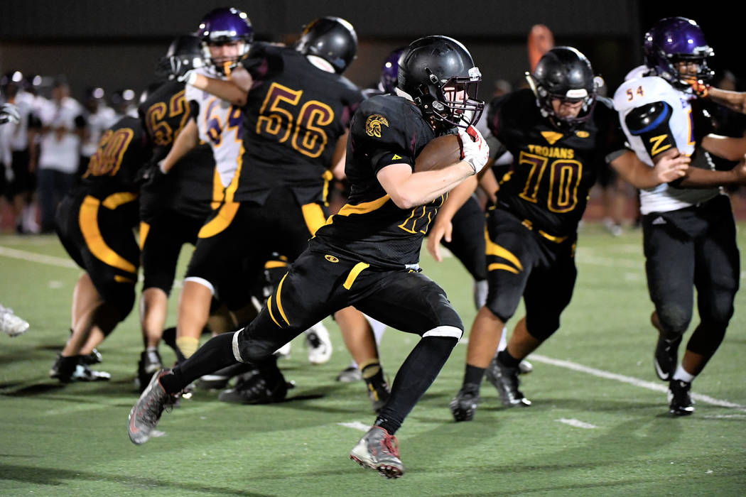 Peter Davis/Special to the Pahrump Valley Times
David Roundy heads for open field in the second half as the Trojans played catch-up with their running game. Pahrump Valley took seven minutes off t ...