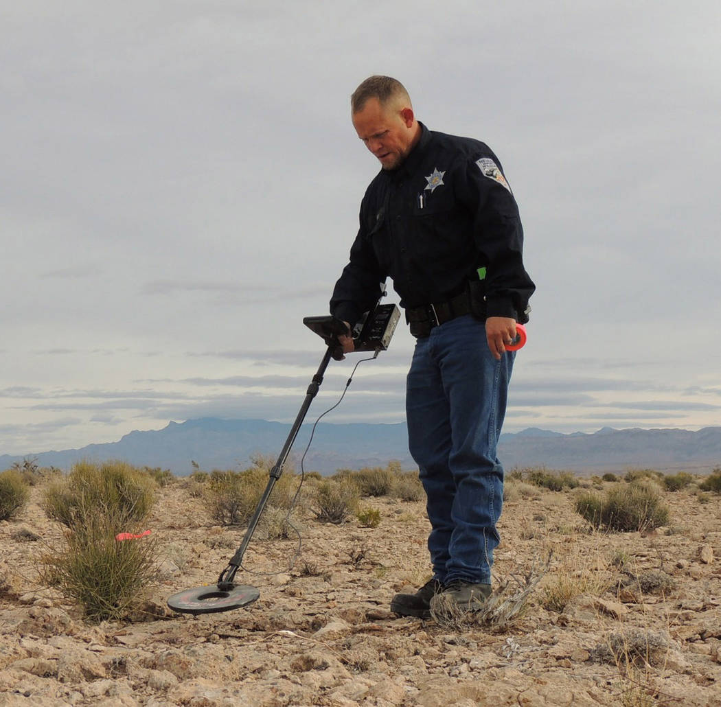Special to the Pahrump Valley Times 
Game Warden Michael Geist looks for evidence using a metal detector near a poaching site in Southern Nevada. A $20,000 reward has been established for any info ...