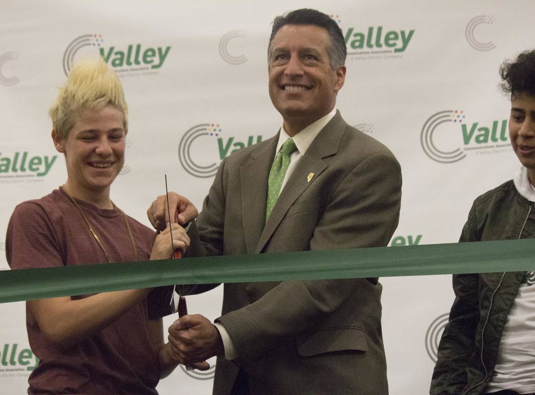 Jeffrey Meehan/Pahrump Valley Times
Gov. Brian Sandoval cuts a green ribbon during an event at Beatty High School recognizing the town to be the first all fiber-optic community in Nevada on Sept.  ...