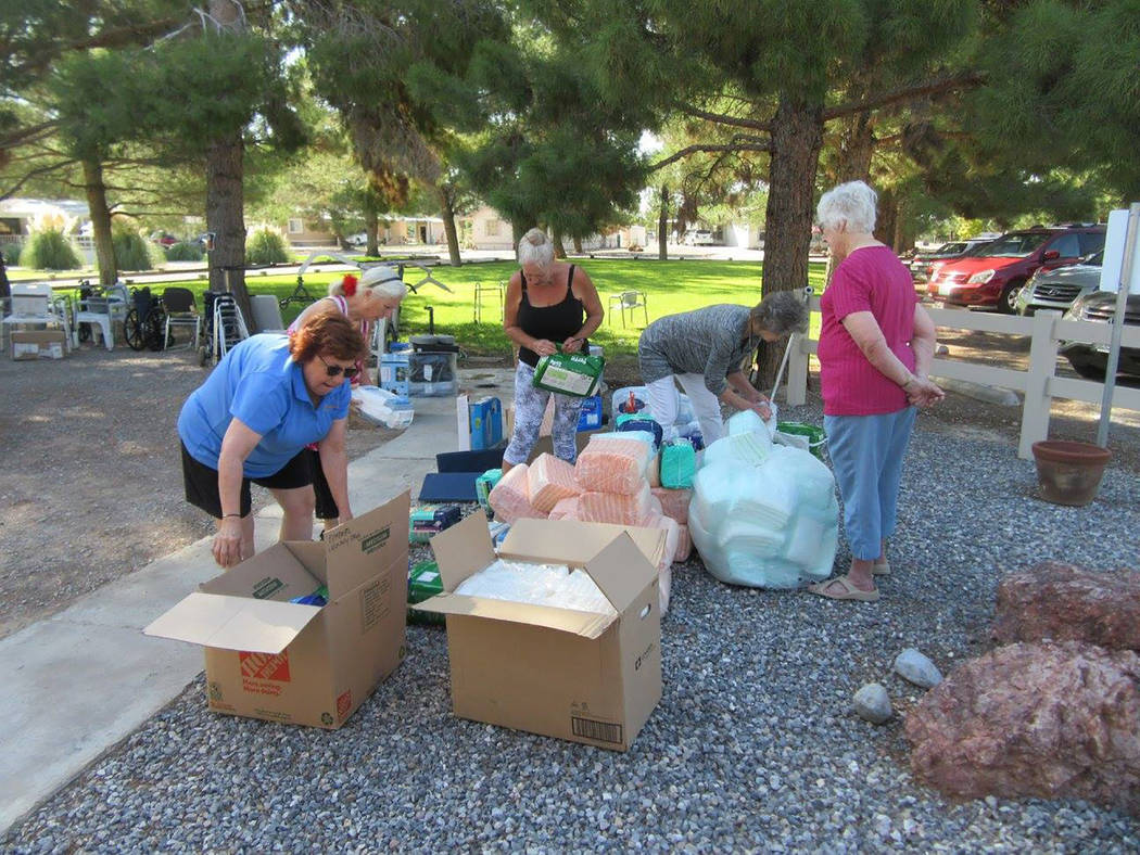 Selwyn Harris/Pahrump Valley Times 
A handful of senior center visitors assist LaaRee Drawantz by helping to unload the supplies. The center had a steady stream of seniors who were grateful for th ...