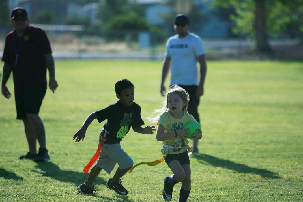 Desiree Castaneda/ Special to the Pahrump Valley Times

Marshawn Lynch, watch out girl! Farra Hudgens, who plays for the Trojan Spear, runs for some tough yards at the flag football scrimmage at S ...