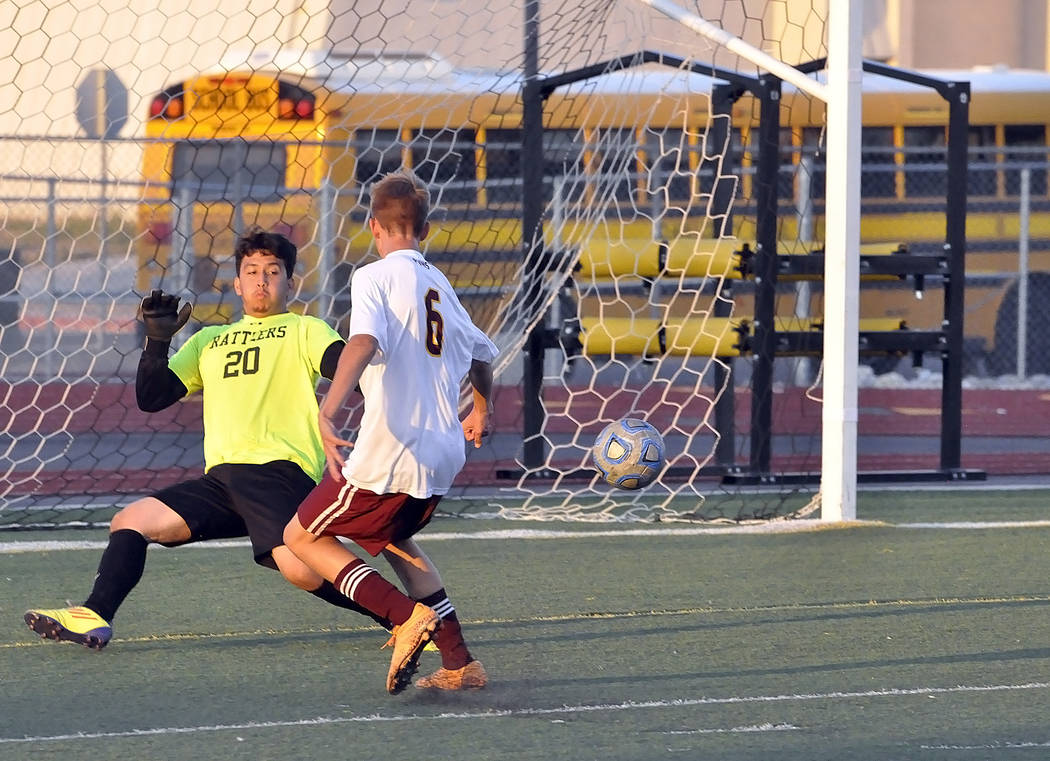 Freshman Vincent DiBlasi puts the ball into the net for a goal. The Trojans came from behind to score three goals in the second half to tie the game.