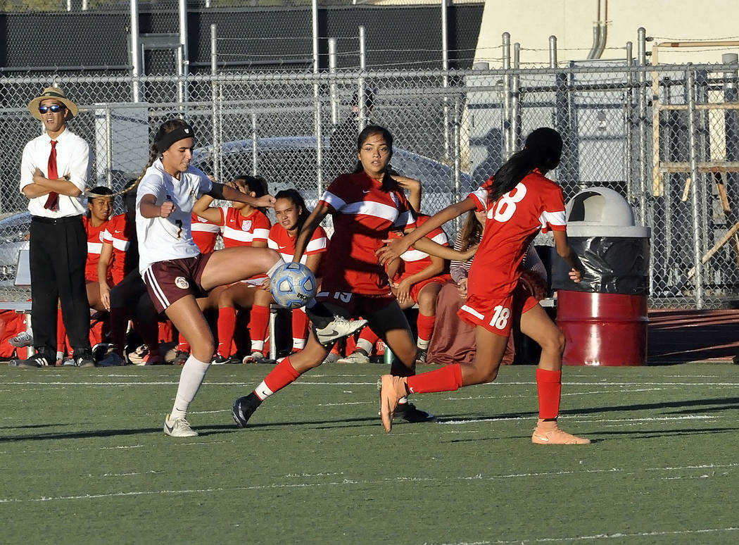 Vaniah Vitto moves the ball away from Western pursuers on Monday night. The Trojans beat Western 2-0.