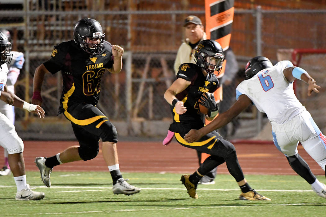 Peter Davis/ Special to the Pahrump Valley Times
Senior quarterback Dylan Coffman runs for extra yardage on Friday night. Coffman had a 49-yard TD run in the first quarter to get the Trojans on th ...