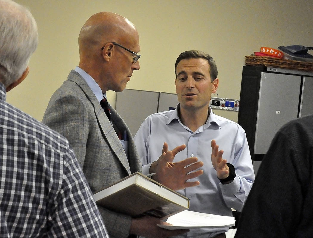 Horace Langford Jr./Pahrump Valley Times 
Bill Stremmel, of Cybertran International, shows Nevada Attorney General Adam Laxalt a book on Yucca Mountain project titled "A Waste of a Mountain." Laxa ...
