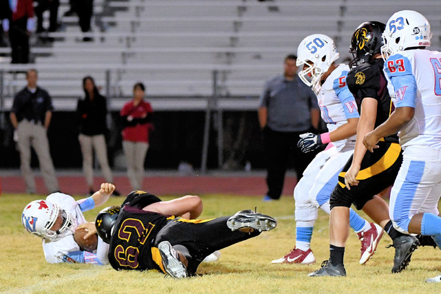 Jeremy Albertson gets a sack the Warriors quarterback. The defense was stellar all night long as the Trojans bottle up the Western offense. 
Peter Davis/ Special to the Pahrump Valley Times