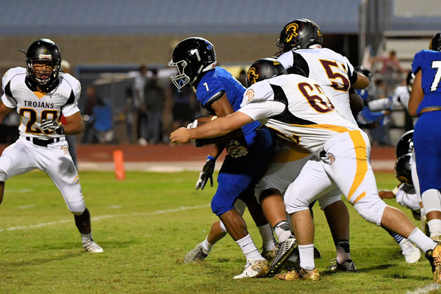 Peter Davis / Special to the Pahrump Valley Times
Above, Trojans defenders trying to contain Jaguar running back Isaiah Morris, who ran for 117-yards rushing and couldn't be stopped.