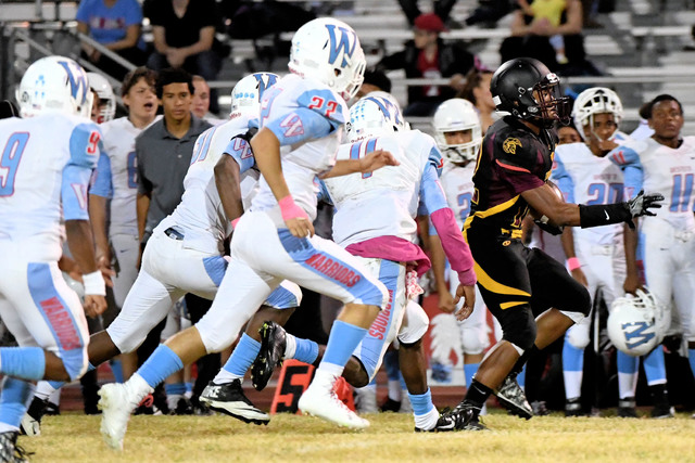 Trojans running back Nickolas Redmond avoids Warrior tackles last Friday. The Trojans ran for 368 yards against Western for the win.
Peter Davis/ Special to the Pahrump Valley Times