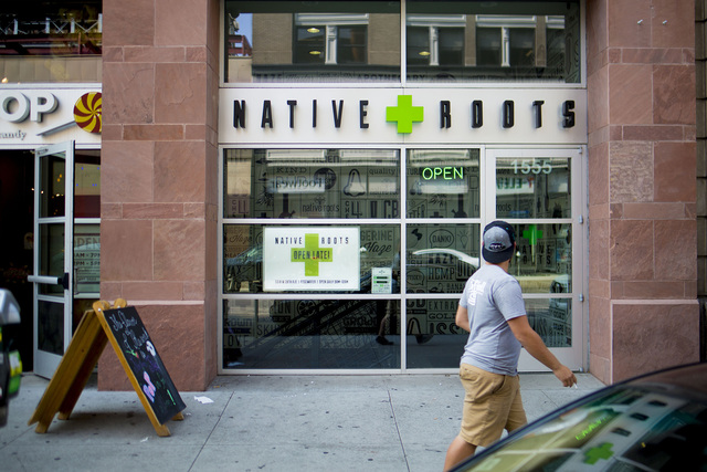 A pedestrian walks pass Native Roots Dispensary where different forms of recreational marijuana can be purchased in Denver, Colorado.  Elizabeth Page Brumley/Special to the Pahrump Valley Times