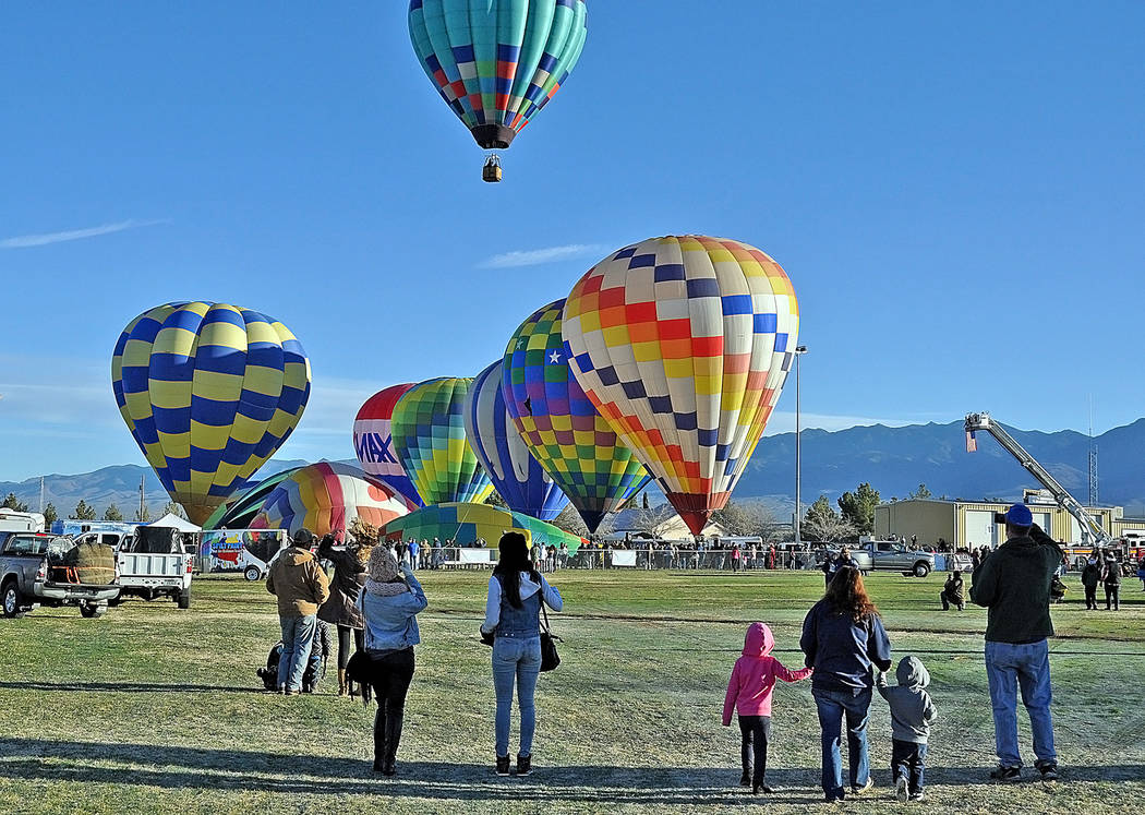 Families and other onlookers pause to watch balloons lift off on Saturday, Feb. 25, day two of the 4th Annual Pahrump Balloon Festival. 
Horace Langford Jr. / Pahrump Valley Times