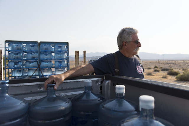 Larry Levy, fire chief with Southern Inyo Fire Protection District, makes his weekly potable water delivery rounds to residents in Tecopa, California. Jason Ogulnik/Special to the Pahrump Valley Times