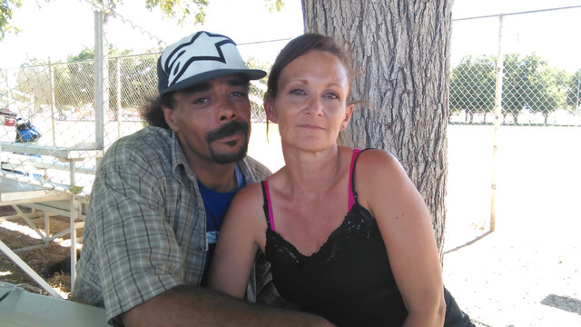 Benjamin Holly and his wife Sheila Theiss take advantage of a shade tree at Petrack Park late last month. The homeless couple, along with two small dogs, moved out of the homeless camp in the dese ...