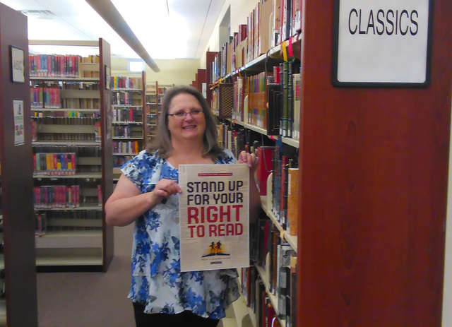 Mandy Cafeo, the Pahrump Community Library assistant director, stands at the classics section as the library prepares for its Banned Book Week observance. The annual national event celebrates the  ...