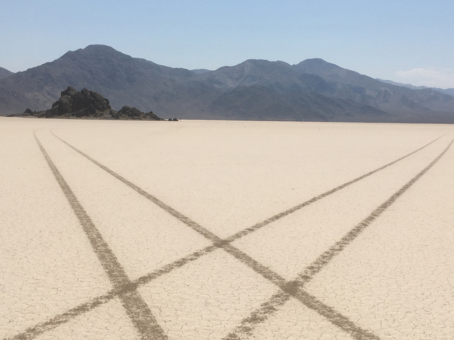 In this undated photo from Death Valley National Park, tire tracks from an illegal joyride crisscross Racetrack Playa near a formation called the Grandstand. 
Courtesy of the National Park Service