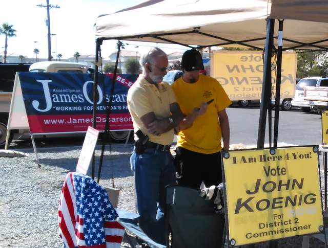 Nye County Commission Candidate John Koenig, left, at his campaign tent outside the Bob Ruub Community Center on Tuesday. The GOP candidate for District II has the only contested commission race i ...