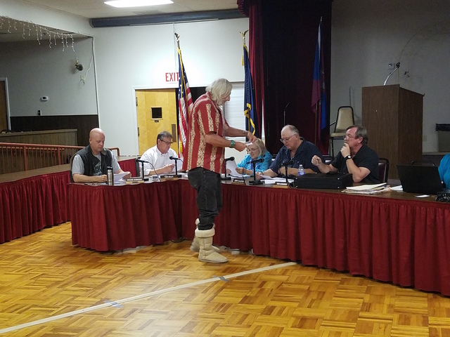 Durk Pearson, standing, hands out a map to the Tonopah Town Board as shown in this Oct. 26 photo. The board is working on a grazing exemption to reassure ranchers as the result of an annexation ap ...