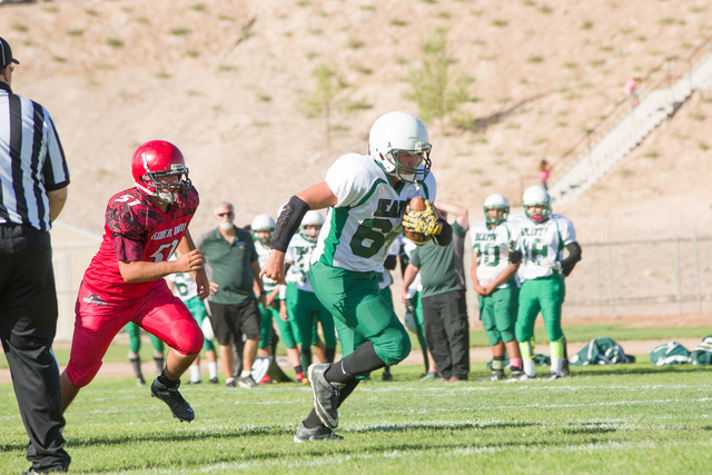 Skylar Stephens / special to the Pahrump Valley Times
Robby Revert runs the ball in a rare moment against Beaver Dam.