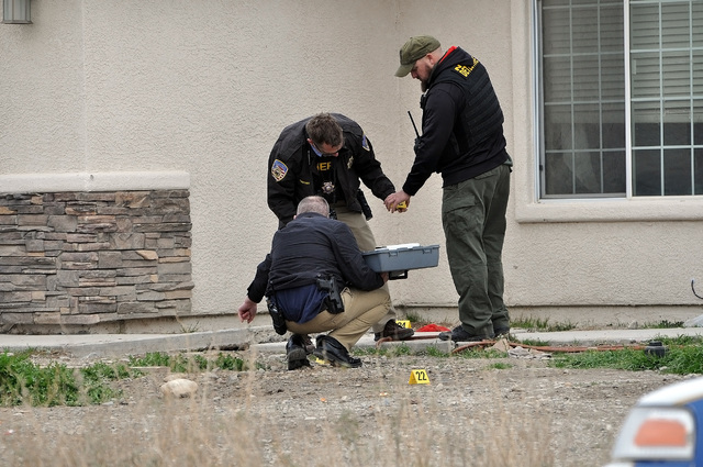 Nye County Sheriff's Office investigators placing numbered markers on spent shell casings found outside the home on  S. Blagg Rd, following a shooting incident in the area.

Horace Langford Jr. /  ...
