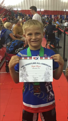 At left, Gunner Cortez (70 pounds)  holds up his certificat for finishing in seventh place in Greco-Roman wrestling at the Asics Kids Nationals in Wisconsin Dells. At right, Brennen Benedict (75 p ...