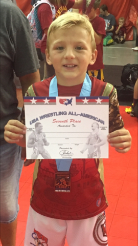 At left, Gunner Cortez (70 pounds)  holds up his certificat for finishing in seventh place in Greco-Roman wrestling at the Asics Kids Nationals in Wisconsin Dells. At right, Brennen Benedict (75 p ...