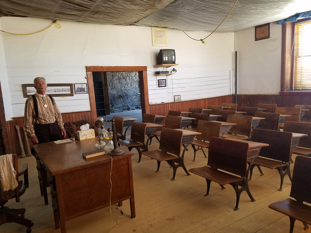 John Ekman, president of the Goldfield Historical Society, is shown inside Goldfield High School in this Aug. 6 photo.  The desks show in this photo were donated by the Fourth Ward School Museum i ...