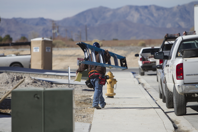 A construction worker carries a ladder while working on a home at the Burson Ranch community by Beazer Homes, Thursday, Feb. 16, 2017, in Pahrump, Nev. (Erik Verduzco/Las Vegas Review-Journal) @Er ...