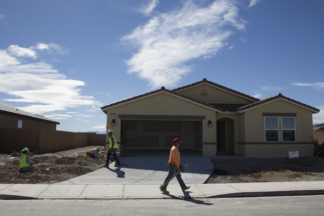 Workers finish homes Feb. 16 at the Burson Ranch community by Beazer Homes in Pahrump. Nye County Planning Director Darrell Lacy said Beazer pulled about 10 permits in the past few months. 
Erik V ...