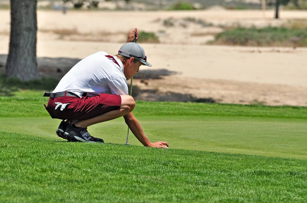 Austen Ancell lines up a putt at the end of last season. The team will need him and his leadership this year if they want to go to state. 
Horace Langford Jr / Pahrump Valley Times