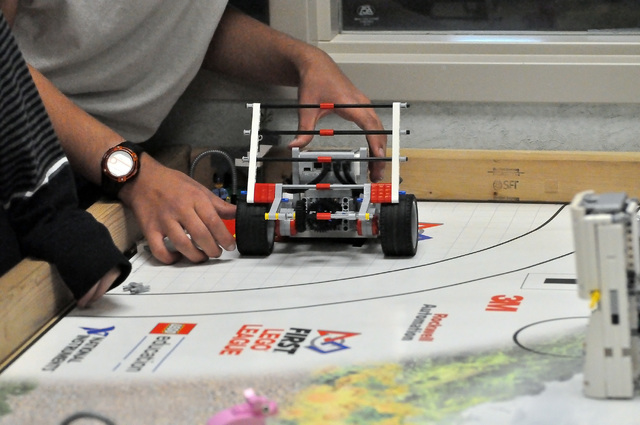 Horace Langford Jr. / Pahrump Valley Times 

A student prepares a Lego robot to complete a task on the robot board. The robots are provided by Lego and the students need to program them and improv ...