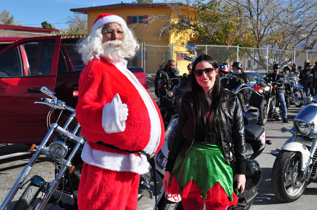 Santa and a helper prepare for the Tribe Motorcycle Toy Run in 2014. The group is seeking toy donations to deliver to area children. Special to the Pahrump Valley Times