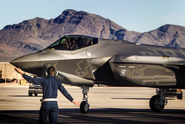 Jeff Scheid/Las Vegas Review-Journal
A flight line member directs at F-35 Lightning II stealth fighter jet at Nellis Air Force Base in 2015.  The high-tech F-35 joint strike fighter jet is the U.S ...