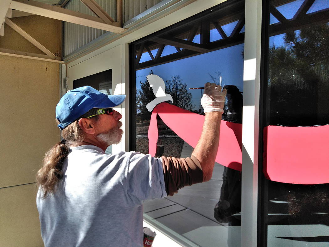 Selwyn Harris/Pahrump Valley Times 
As a professional holiday window artist, Douglas “Dok” Hembree adds some holiday pizzazz to a window pane at the Ian Deutch Government Complex on East Basin ...
