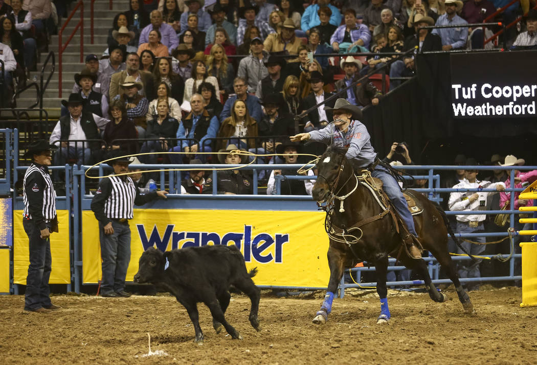 Tuf Cooper of Weatherford, Texas takes part in the tie-down roping competition in the tenth go-round of the National Finals Rodeo, Saturday, Dec. 16, 2017, at the Thomas & Mack Center in Las V ...