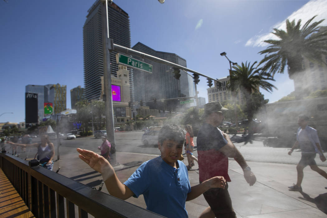Richard Brian/Special to the Pahrump Valley Times
Pedestrians cool off on water misters along Las Vegas Boulevard in Las Vegas on Thursday, May 25, 2017. The Las Vegas Valley registered its hottes ...