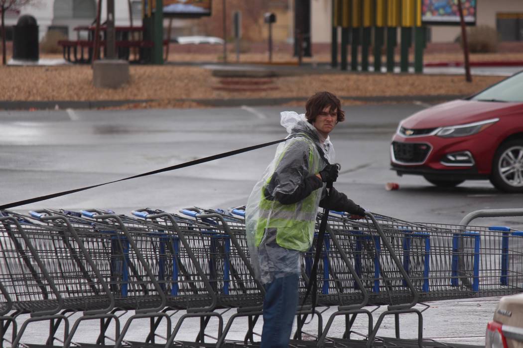 Jeffrey Meehan/Pahrump Valley Times
Employee at the Pahrump Walmart pushes carts through a wet parking lot, as rain returns to the Pahrump Valley after 116 days without precipitation. The stretch  ...