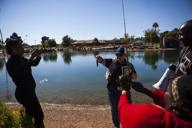 Miranda Alam/Las Vegas Review-Journal 
Ivy Santee, Angler education coordinator of Southern Nevada for the Department of Wildlife, holds up the fish caught by Emma Barlow, bottom right, during a s ...