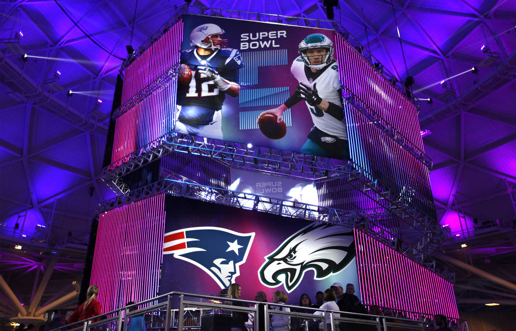 A banner featuring New England Patriots quarterback Tom Brady, left, and Philadelphia Eagles quarterback Nick Foles is a centerpiece inside the NFL Experience at the Minneapolis Convention Center  ...