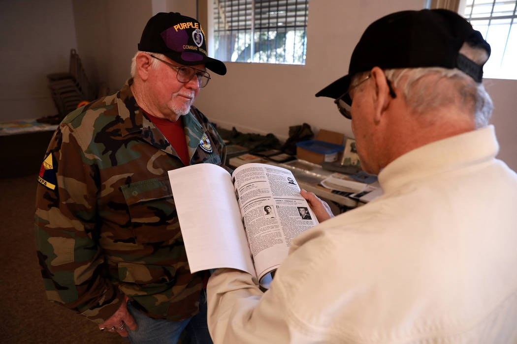 Veterans Bob Haygood, left, and Larry Hastings look at war memorabilia during a 50th anniversary event remembering the Vietnam War Tet Offensive at the American Legion Vegas Post 8 in Las Vegas, S ...