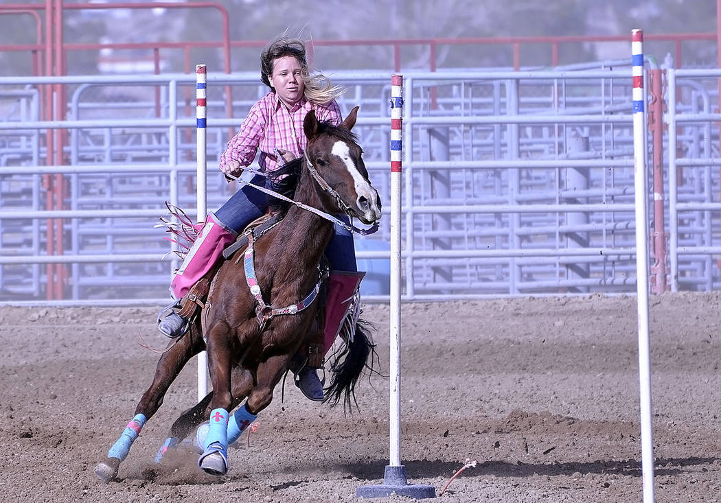 Horace Langford Jr./Pahrump Valley Times - Pole bending was yet another competition the youth were able to participate in. Karen Young is shown directing her horse through the obstacle.