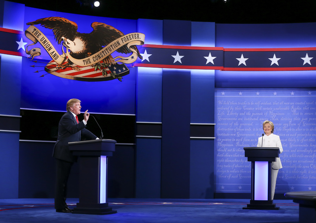 Republican presidential candidate Donald Trump, left, and Democratic presidential candidate Hillary Clinton speak during the third presidential debate at the Thomas & Mack Center at UNLV in La ...